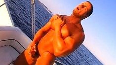 Muscled stud caresses his hot body and pleases his big dick on a boat