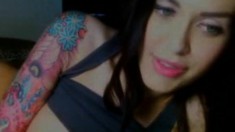Tattooed brunette shows off her fabulous tits and ass on the webcam